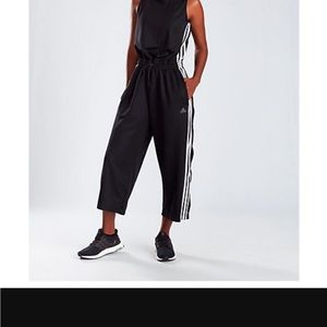 Adidas black jumpsuit sleeves with white stripes down sides.